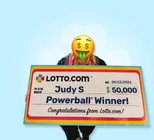 Winner Judy S. holds a check for $50,000 in her hands